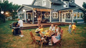 A happy family enjoys a cookout outside of a perfectly cooled home