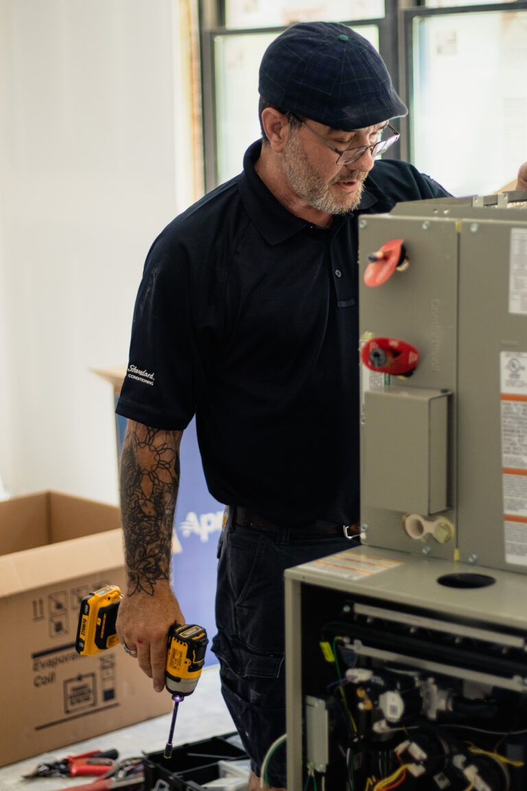 technician working on a geothermal heat pump